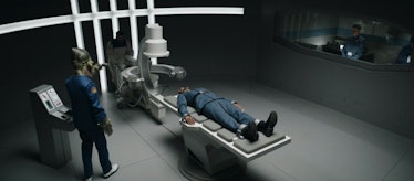 Omid Abtahi's Dr. Pershing lies strapped to a metal table in The Mandalorian Season 3 Episode 9