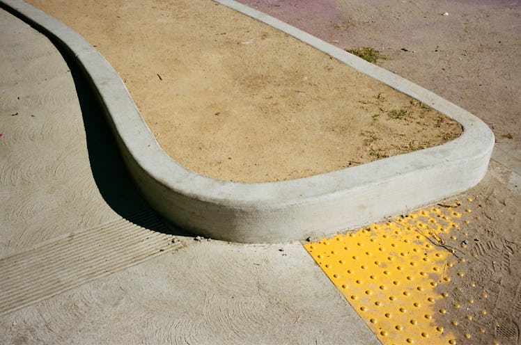 a photograph of a dirt filled rounded curb