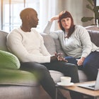 Man and woman having serious discussion on couch