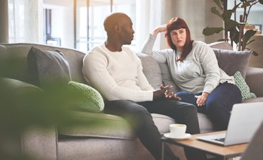 Man and woman having serious discussion on couch