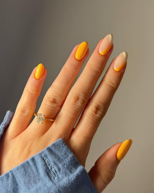 Bright orange is one of the best nail colors for spring 2023.