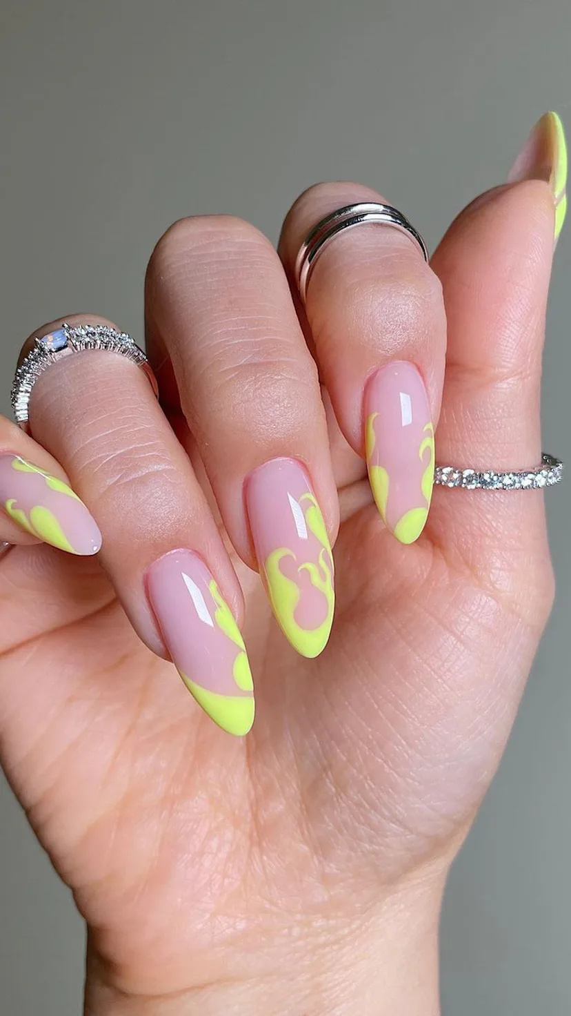 Try neon yellow flame nail art for Aries season 2023.