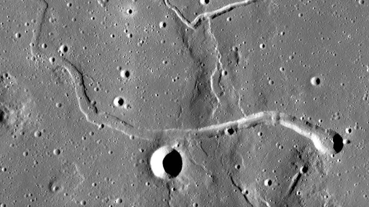 portion of moon with several craters shown