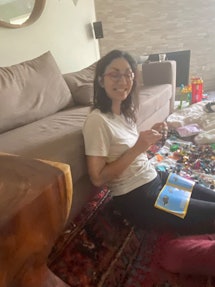 woman sitting on the floor with Legos