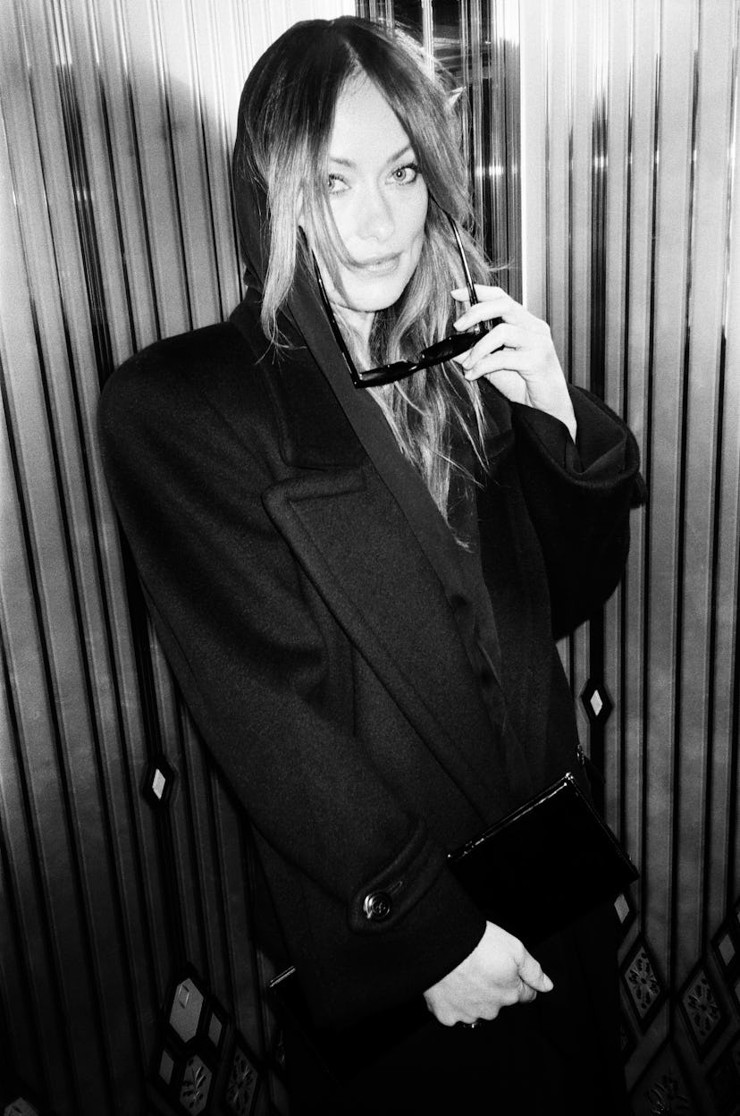 A black and white photograph of Olivia Wilde at Paris fashion week