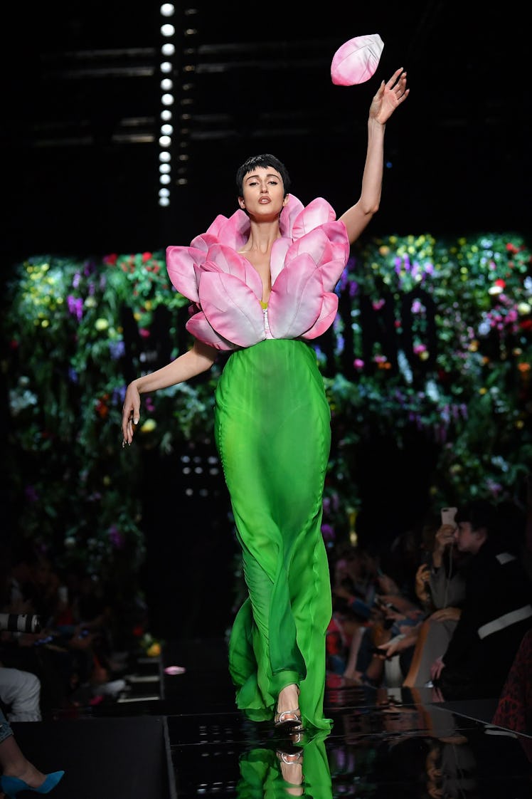 Model Anna Cleveland presents a creation for fashion house Moschino during the Women's Spring/Summer...