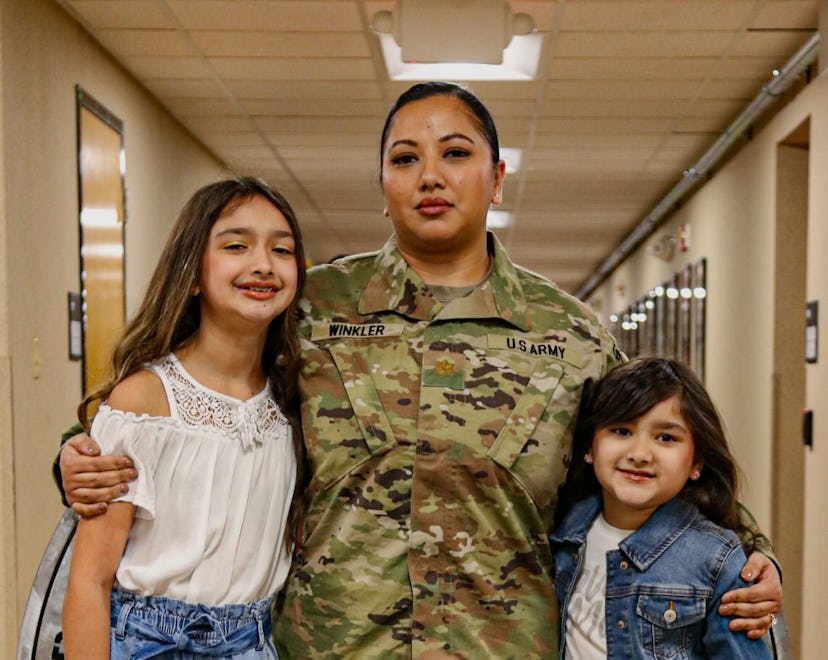 Major Sam Winkler, in uniform, and her daughters.
