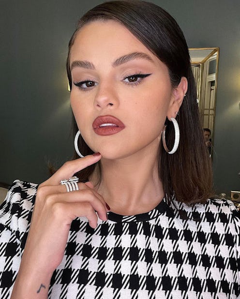 Selena Gomez hoop earrings and dark lipstick