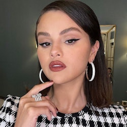 Selena Gomez hoop earrings and dark lipstick