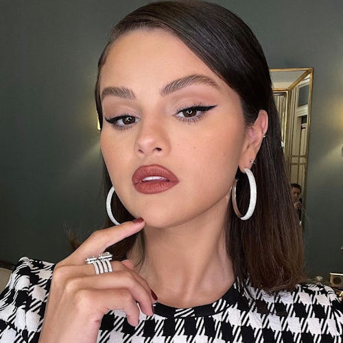 Selena Gomez hoop earrings and dark lipstick
