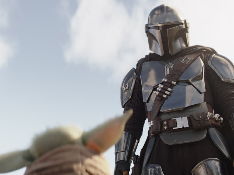 Din Djarin (Pedro Pascal) looks down at Grogu in The Mandalorian Season 3 Episode 4