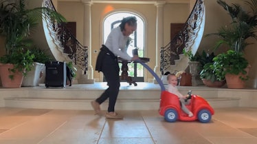 Doria Ragland pushes her grandson Archie in a toy car. 