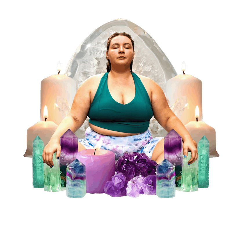 a woman meditating and clearing her energy with crystals and candles