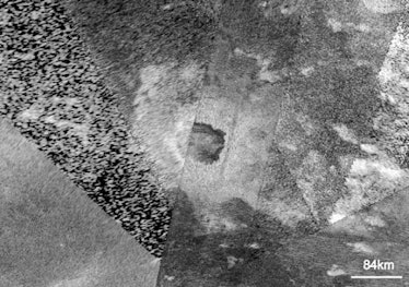 aerial view of a crater on an icy moon