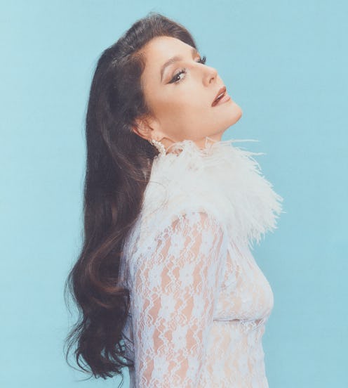 Jessie Ware wearing a feathered frock and looking fierce