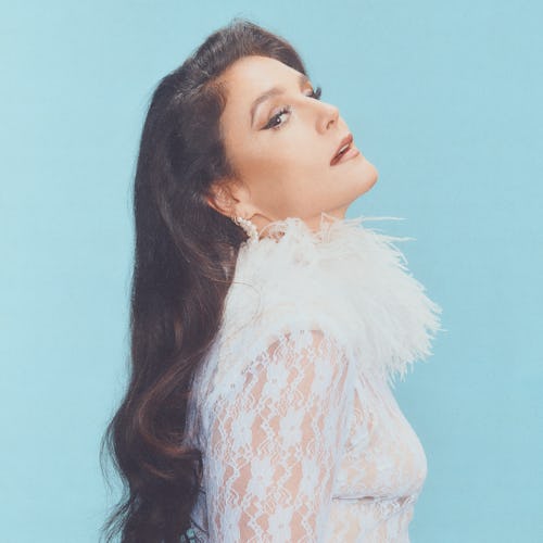 Jessie Ware wearing a feathered frock and looking fierce