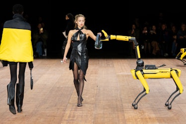 Lila Grace Moss walks the runway with a robot at the Coperni Womenswear Fall Winter 2023-2024 show d...