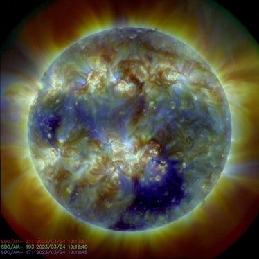 The Sun's round body is surrounded by wisps of expelled material. The body is full of swirls.