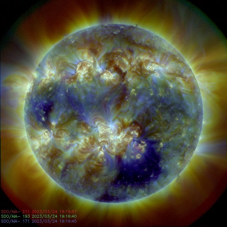 The Sun's round body is surrounded by wisps of expelled material. The body is full of swirls.