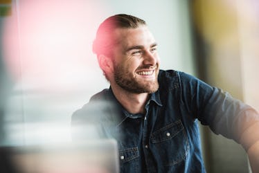 Adult man smiling happily after receiving a compliment