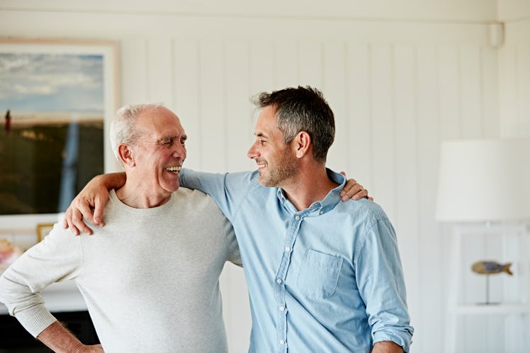 Happy middle aged man with his arm around his father