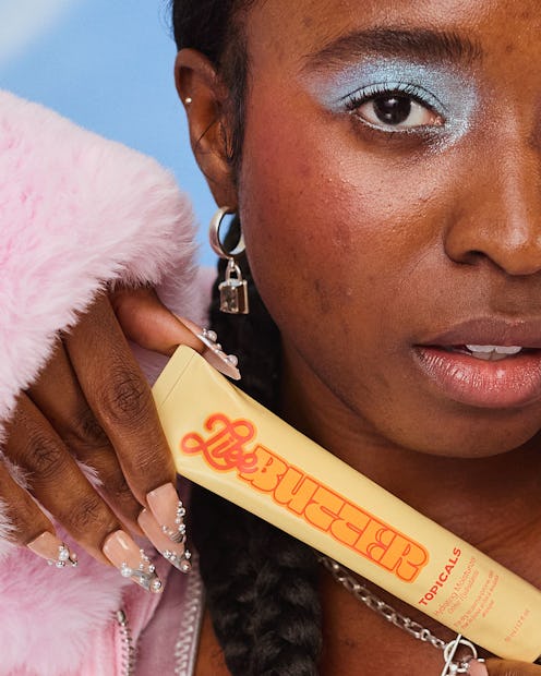 Topicals Like Butter Moisturizer model holding product