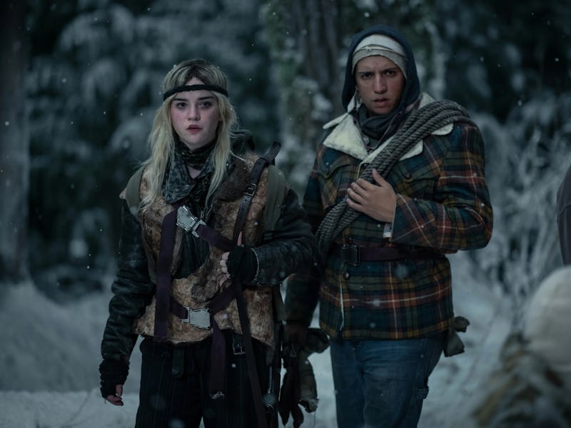 Natalie and Travis stand in the snowy woods together in Yellowjackets Season 2