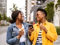 An Aries and Cancer laughing outside because their friendship compatibility is off the charts.