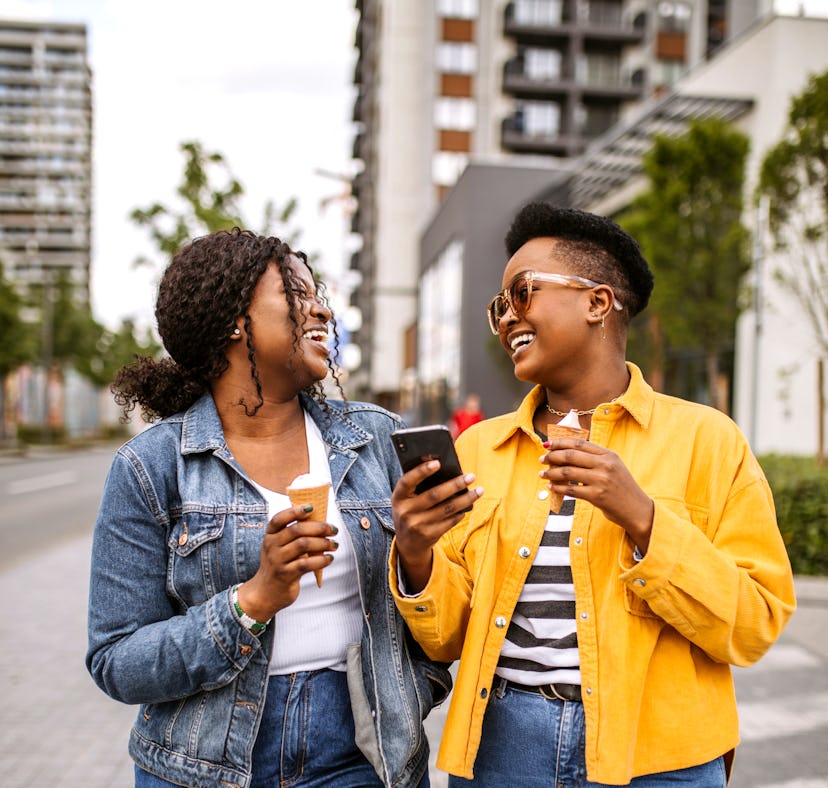 An Aries and Cancer laughing outside because their friendship compatibility is off the charts.