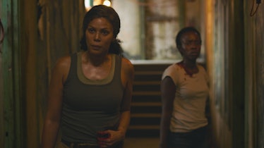 Merle Dandridge and Natasha Mumba stand in a hallway in The Last of Us Episode 1