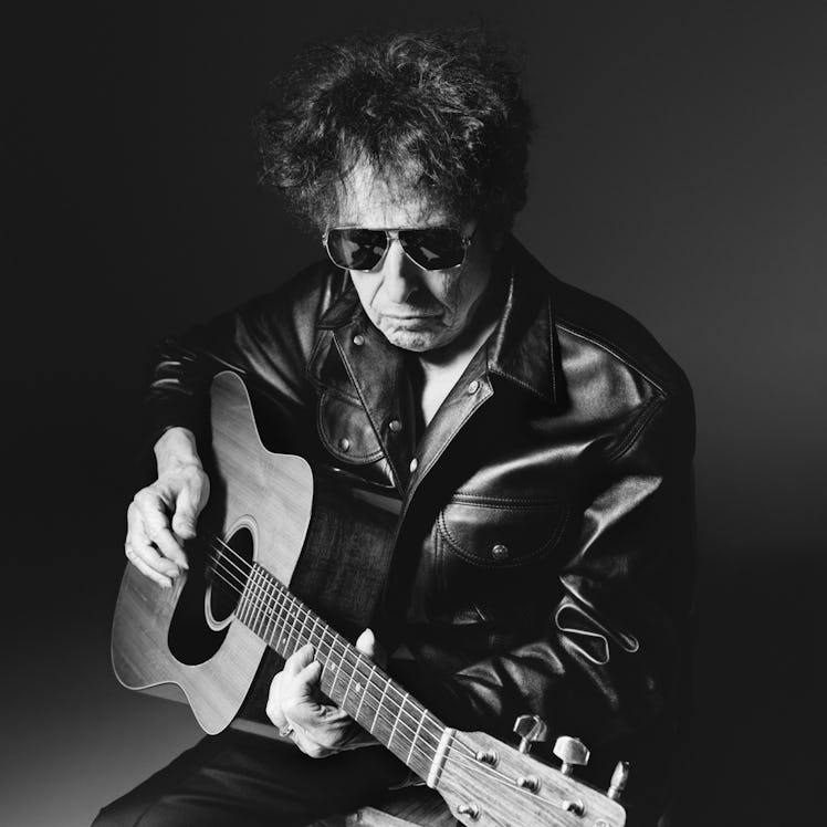 bob dylan in the celine hedi slimane black and white photographs playing a guitar