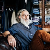 Bearded middle aged man relaxing in men's store. 