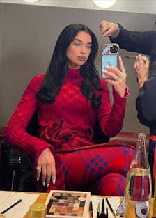 Dua wearing a full red Burberry check outfit