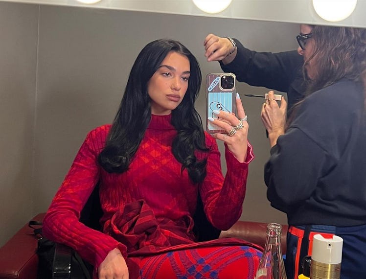 Dua wearing a full red Burberry check outfit