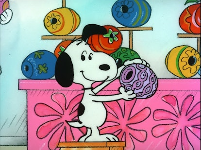 Snoopy looking at colored Easter eggs in 'It's The Easter Beagle, Charlie Brown.'