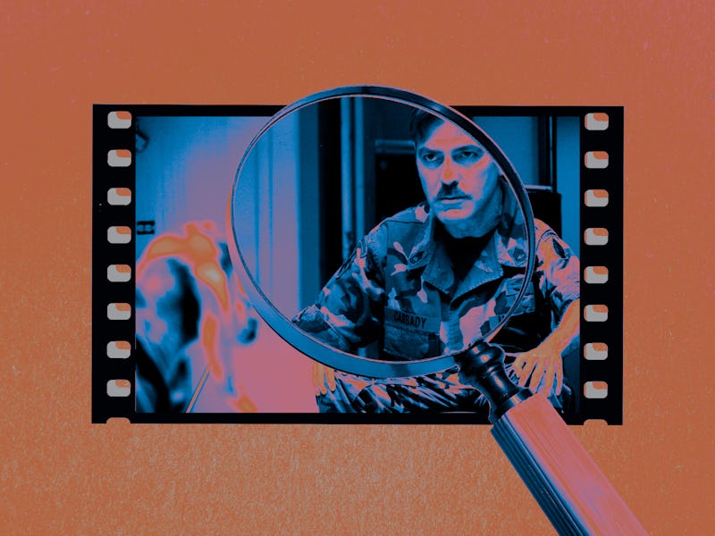 george clooney in a film cell with a weird mustache. a magnifying glass is over clooney. the film is...