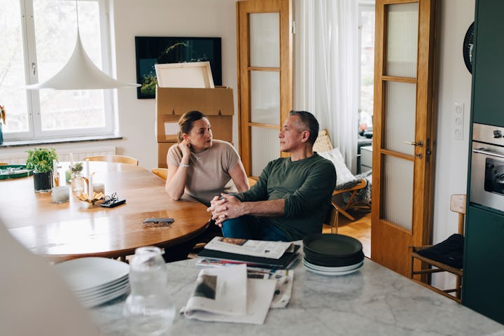 Husband and wife sitting at home having a serious conversation