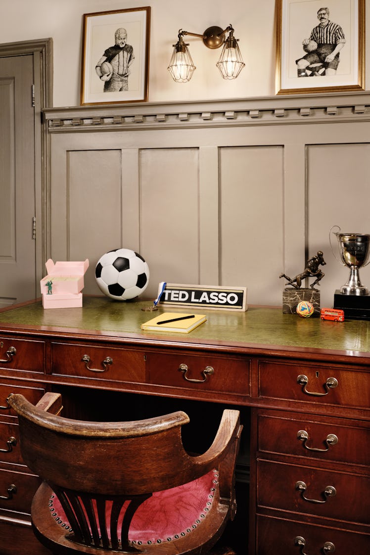 The 'Ted Lasso' Airbnb has his desk with little green army men and pink boxes for Ted Lasso biscuits...