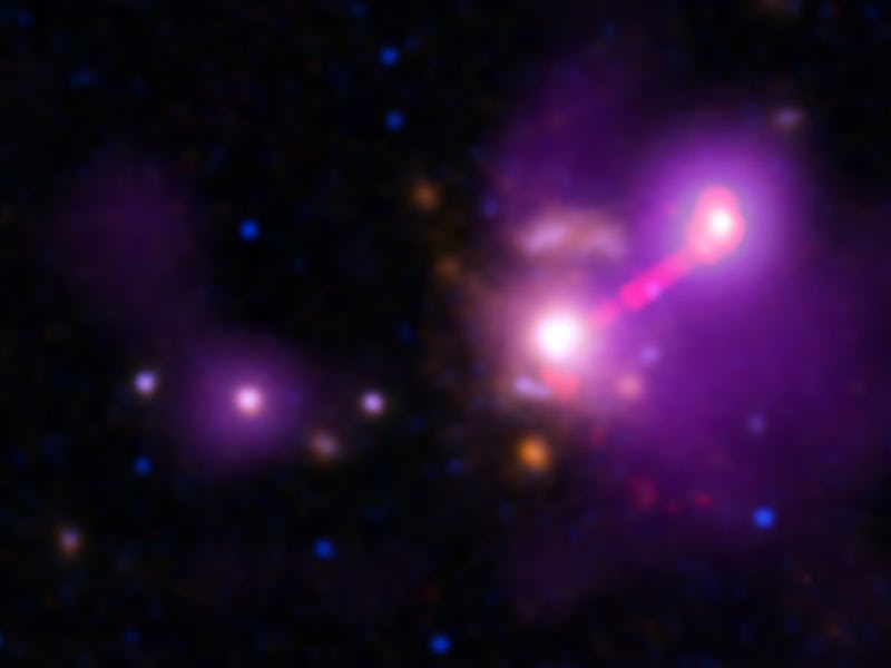 The brightest point represents the active center of a galaxy located more than 9 billion light years...