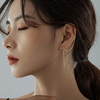 These earrings that look like multiple piercings feature a helix cuff and a dangling chain.