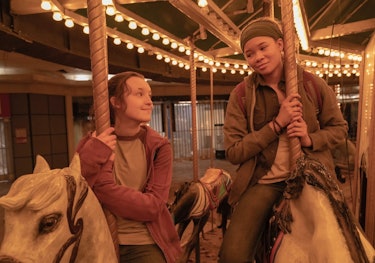 Ellie (Bella Ramsey) and Riley (Storm Reid) ride on a carousel in the mall in 'The Last of Us.'