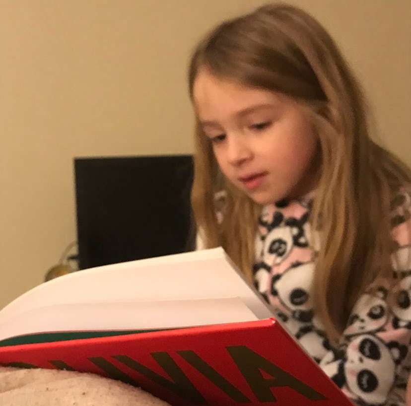 The author's daughter reading an 'Olivia' book. 