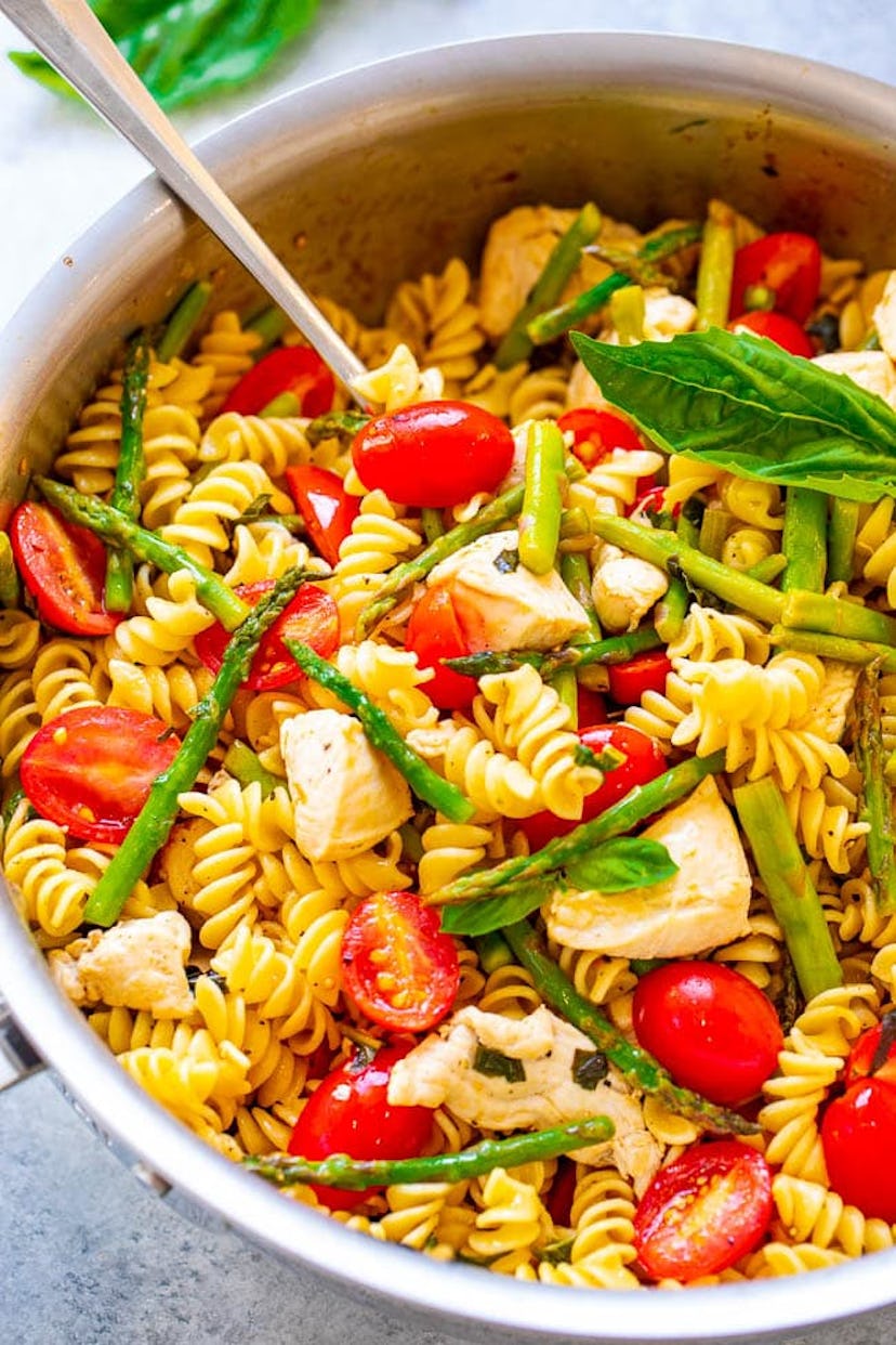 bowl of chicken and pasta with asparagus and tomatoes spring recipe