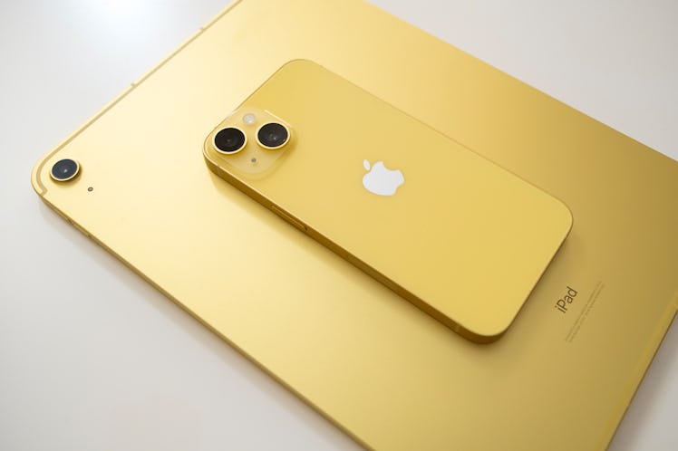 The yellow iPhone 14 has a glass back compared to the anodized aluminum on the yellow iPad (10th-gen...