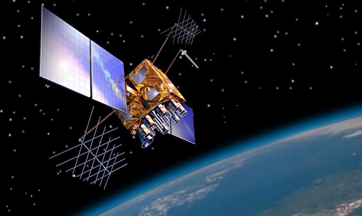 photo of a satellite in space with shiny solar panels and a blue planet below