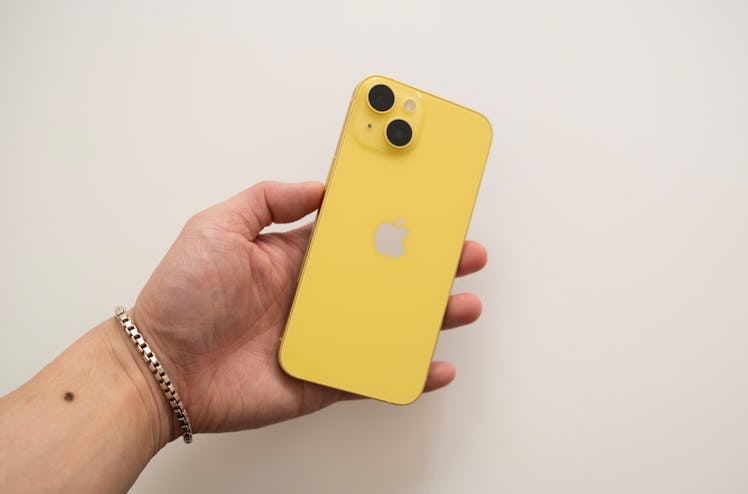 yellow iphone 14 plus in hand