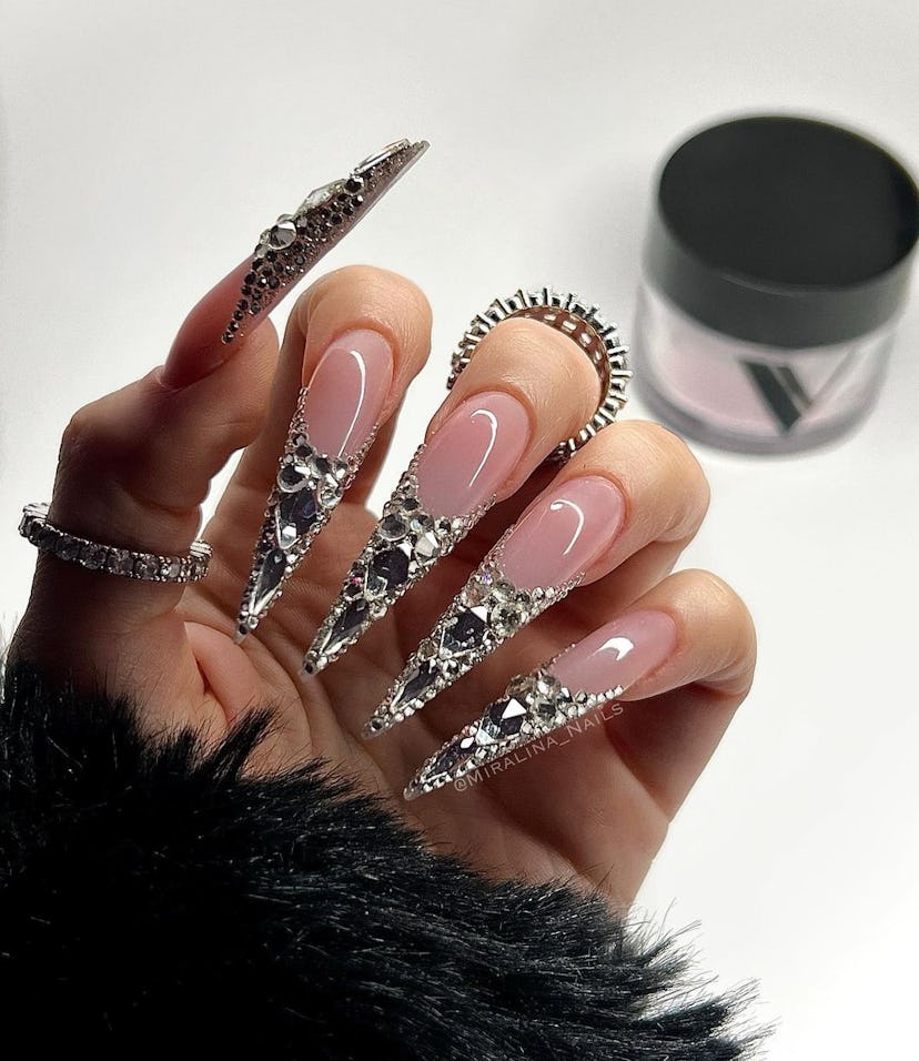 Need a glamorous idea for vacation nails? Try a stiletto nails with gems.