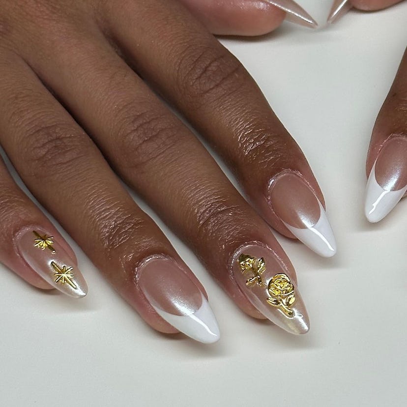 A glazed French manicure with gold designs is a great idea for vacation nails.