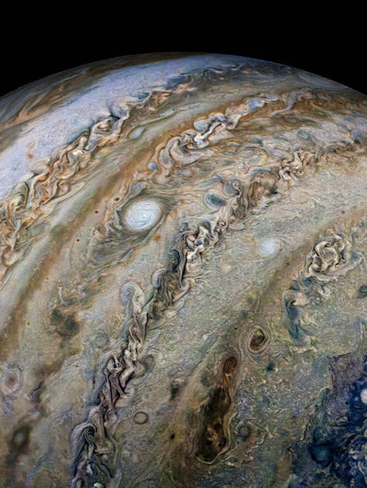 The icy moon Ganymede creates a round shadow over Jupiter's cloud tops. NASA's Juno spacecraft took ...