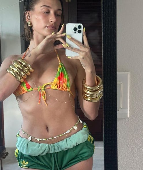 Hailey Bieber's yellow nails are great manicure inspiration for your next beach vacation.